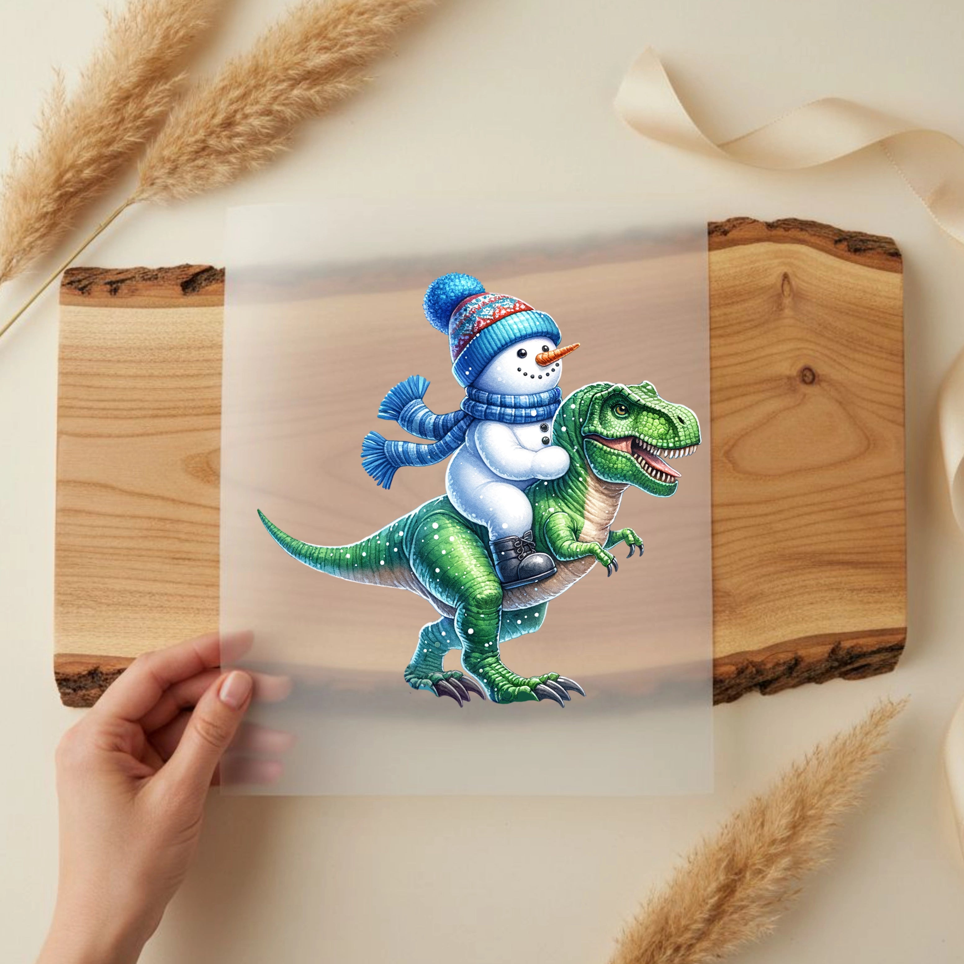 Bügelbild Schneemannritt auf Dinosaurier