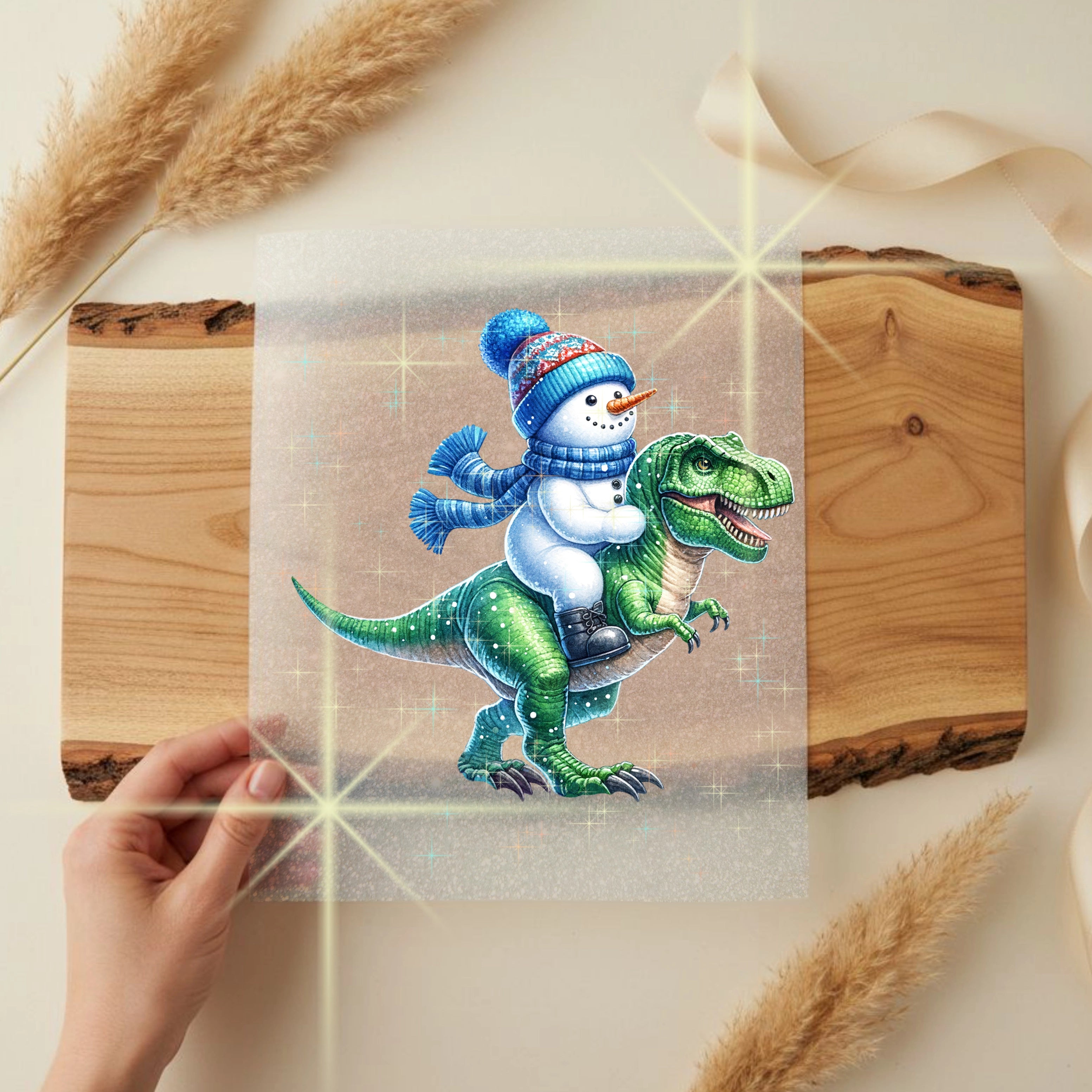 Glitzer Bügelbild Schneemannritt auf Dinosaurier